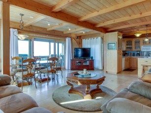 Enjoy decks, ocean views, private hot tub & shared pool/sauna by golf & trails!